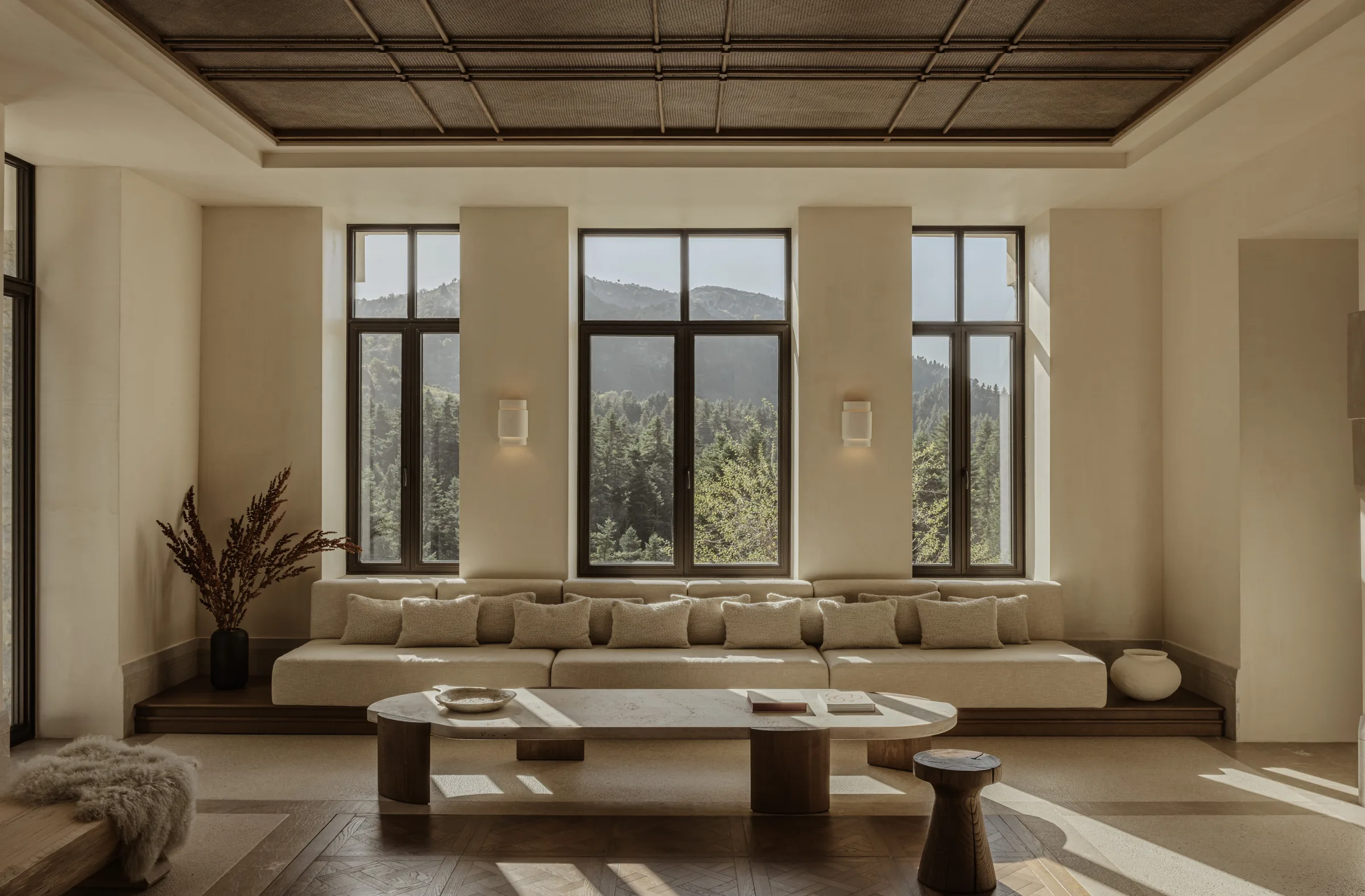 A quiet MANNA lounge opening toward the fir forest