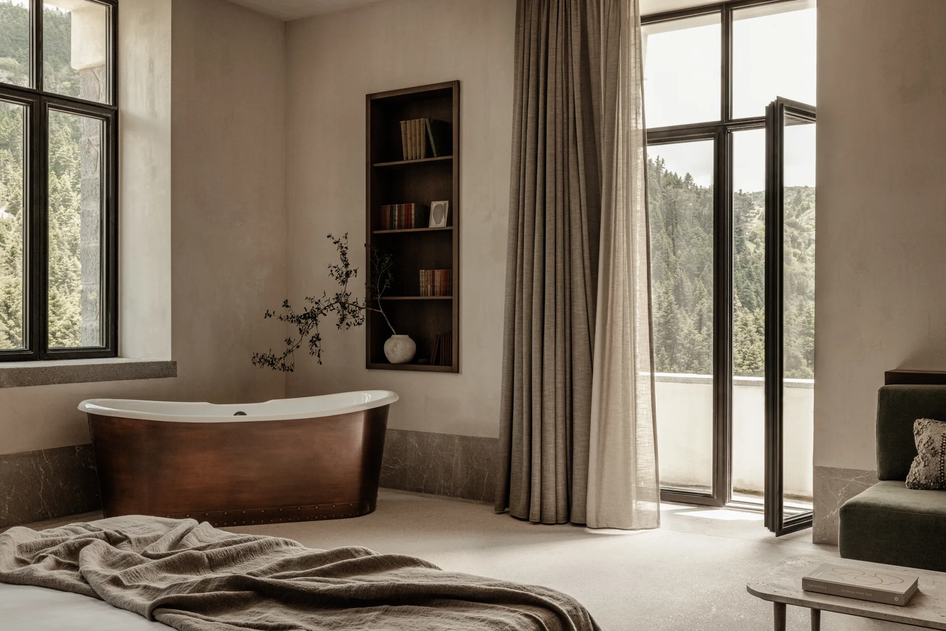 MANNA suite with a freestanding copper bath and forest views