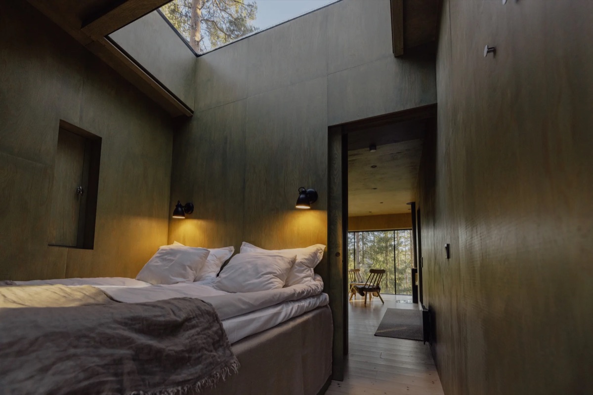 A timber suite looking into the spruce forest at Trakt Forest Hotel