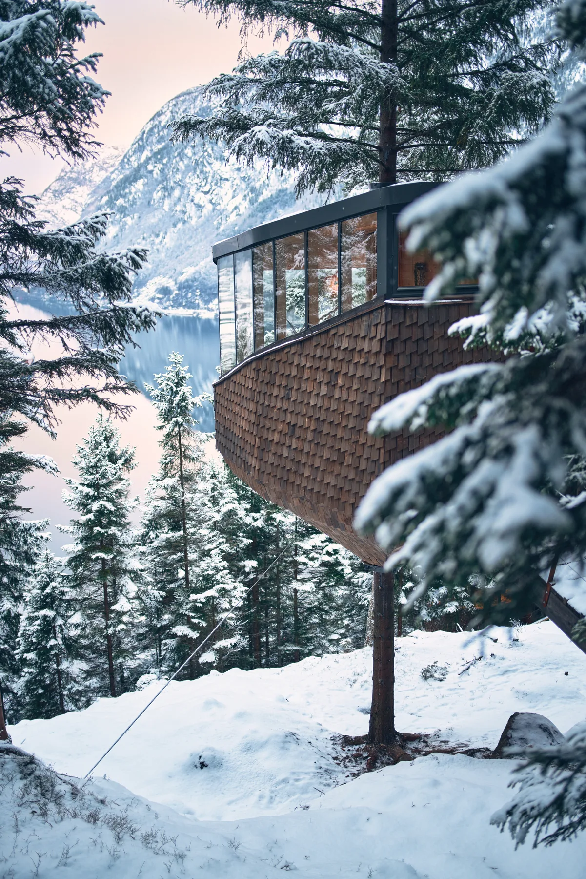 A Woodnest treehouse in snow overlooking the Hardangerfjord and surrounding mountains